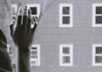 hand against rainy window