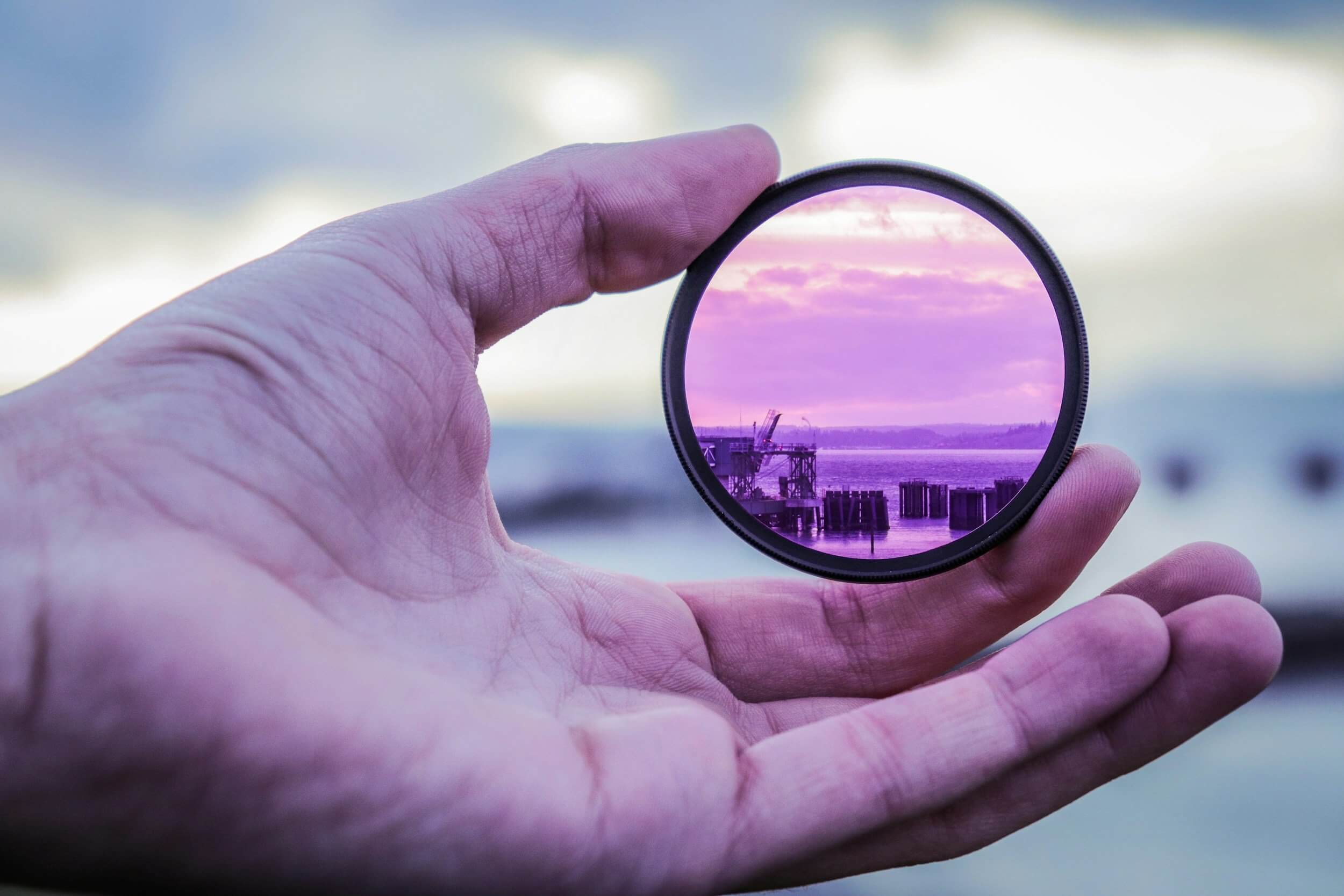 hand holding a purple filter hand holding a purple filter