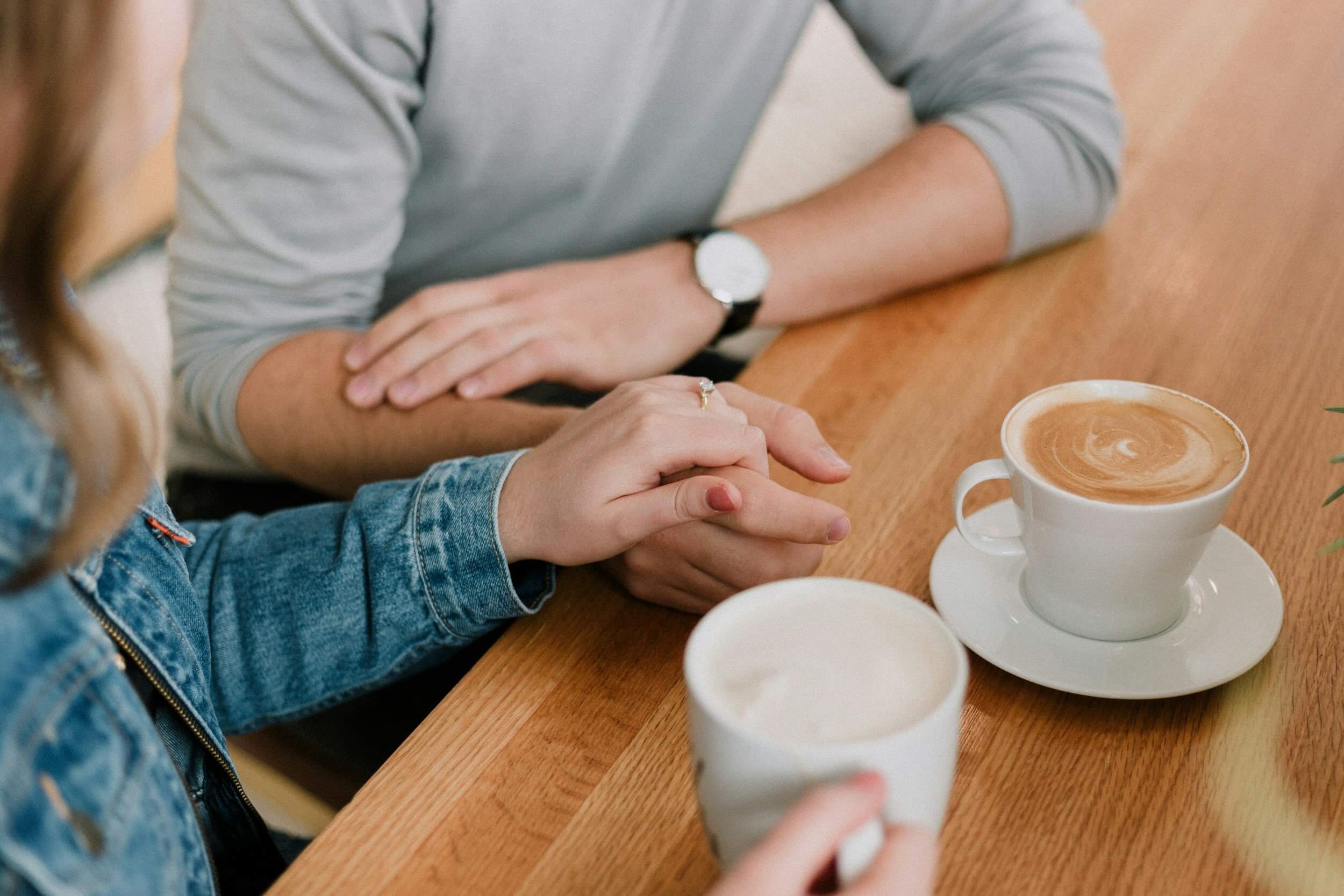 holding hands on a coffee date