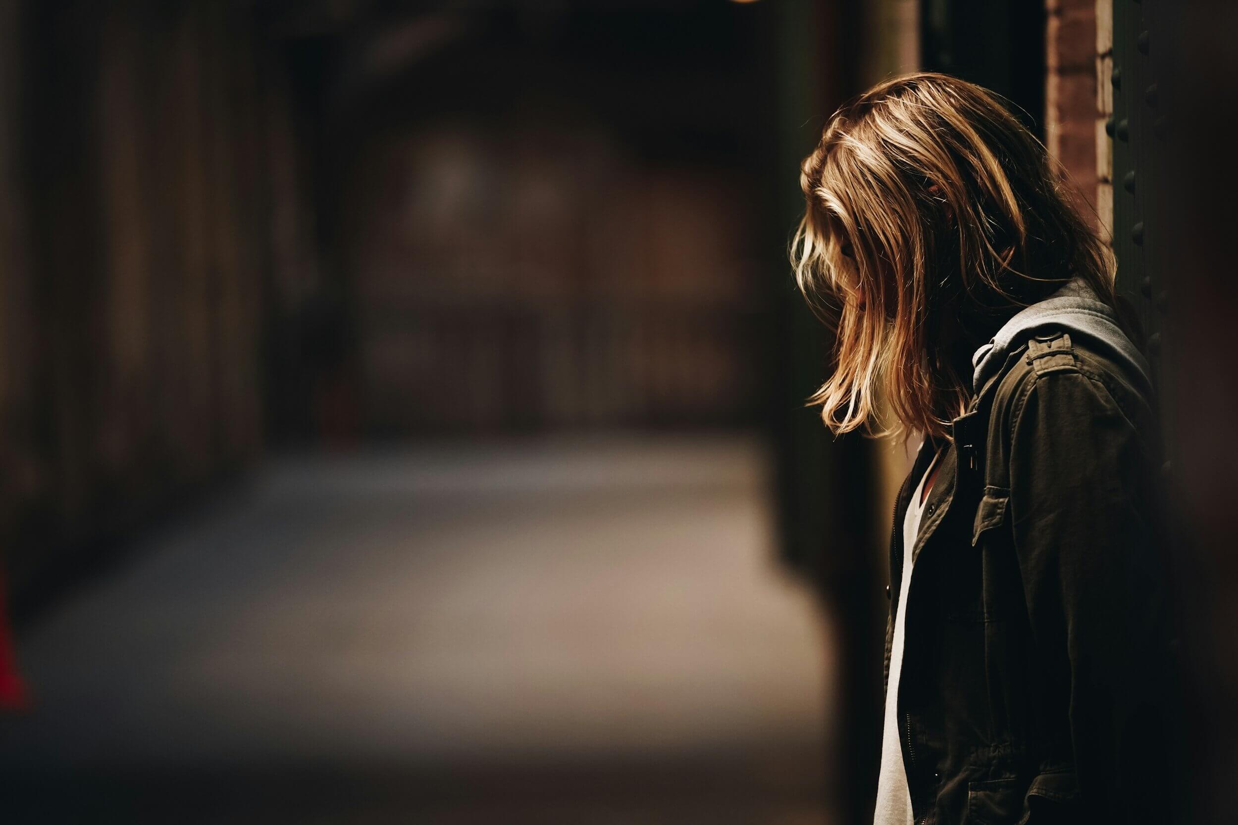lonely woman in a dim alley lonely woman in a dim alley