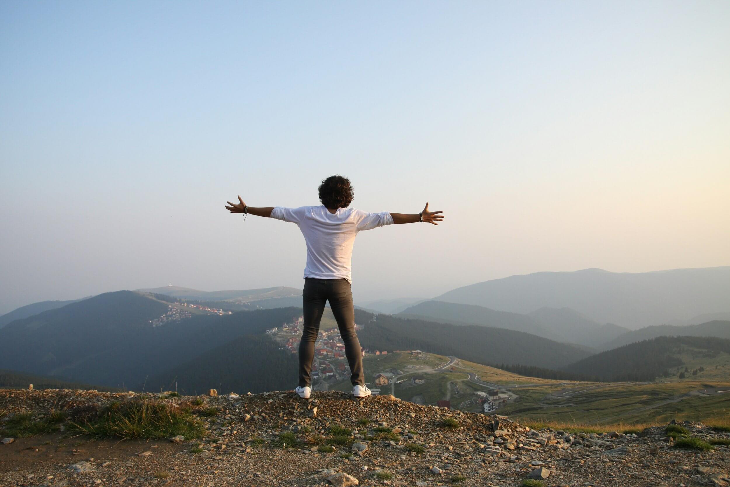 man overlooking mountain valley