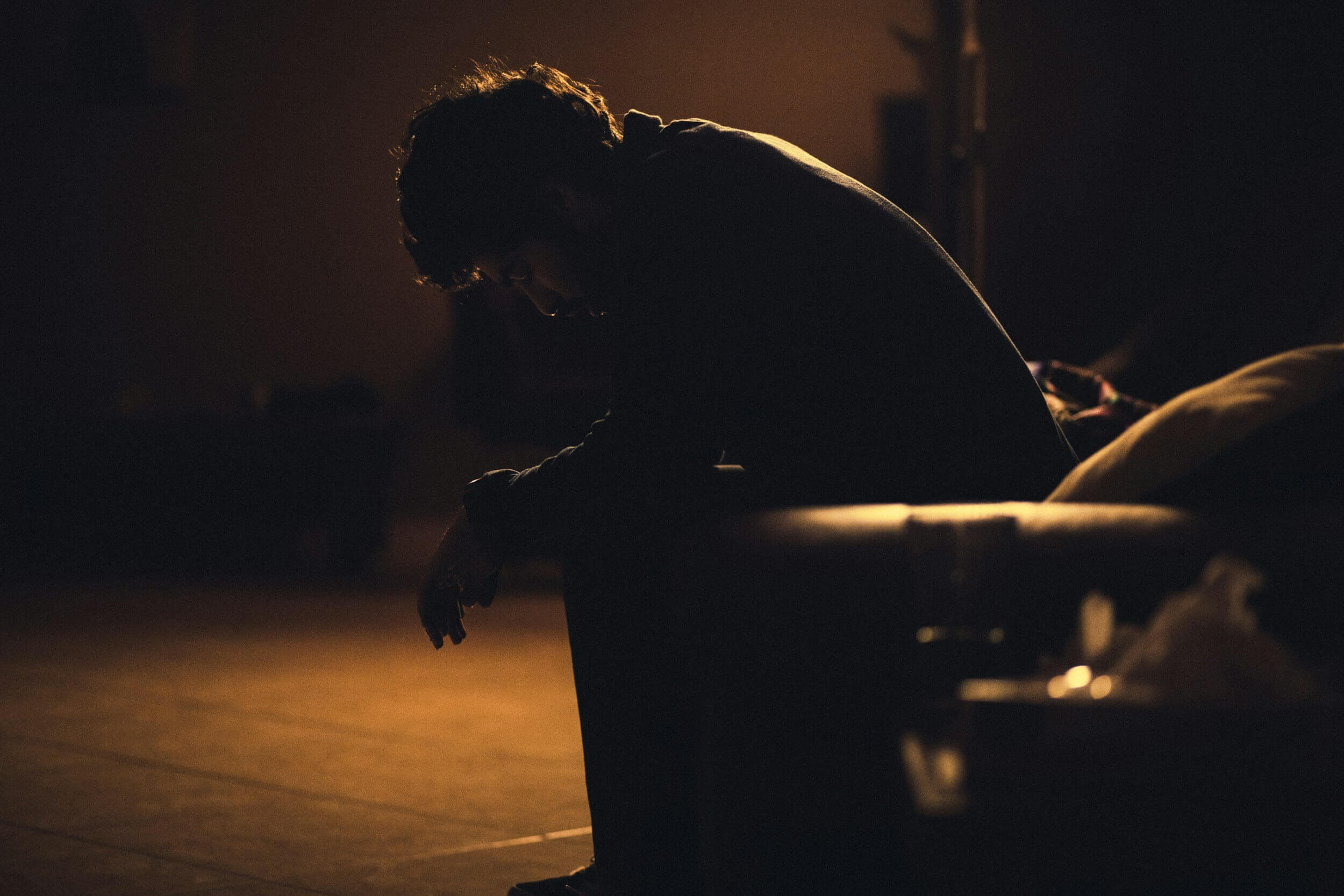 man sitting in shadow man sitting in shadow