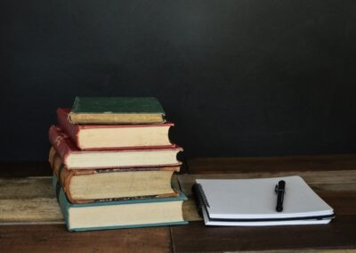 stacked books with notebook