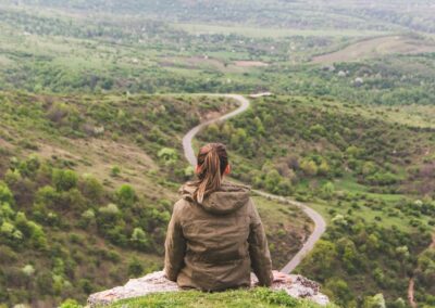 woman overlooking winding road