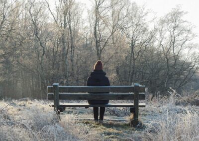 Girl sitting on a bench with trees