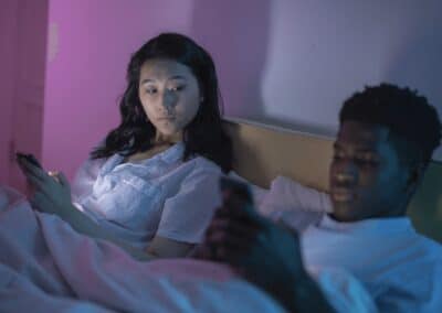 couple in bed on their phones