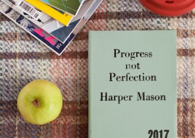 magazine, apple and book on cloth