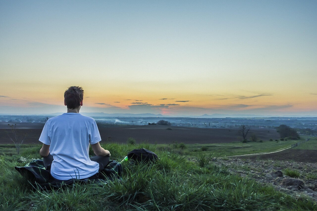 Man meditating outside