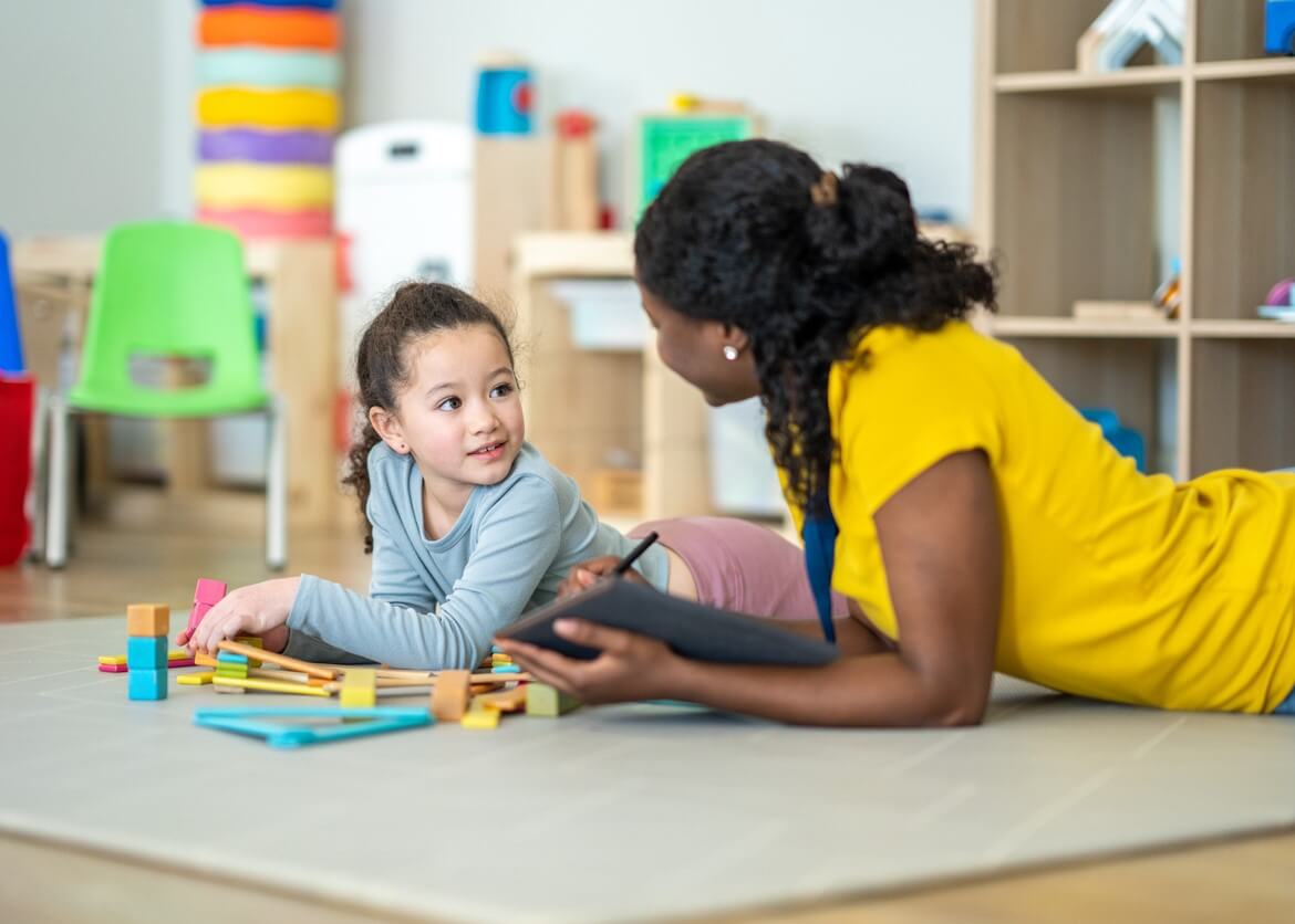 therapist and child playing on the floor