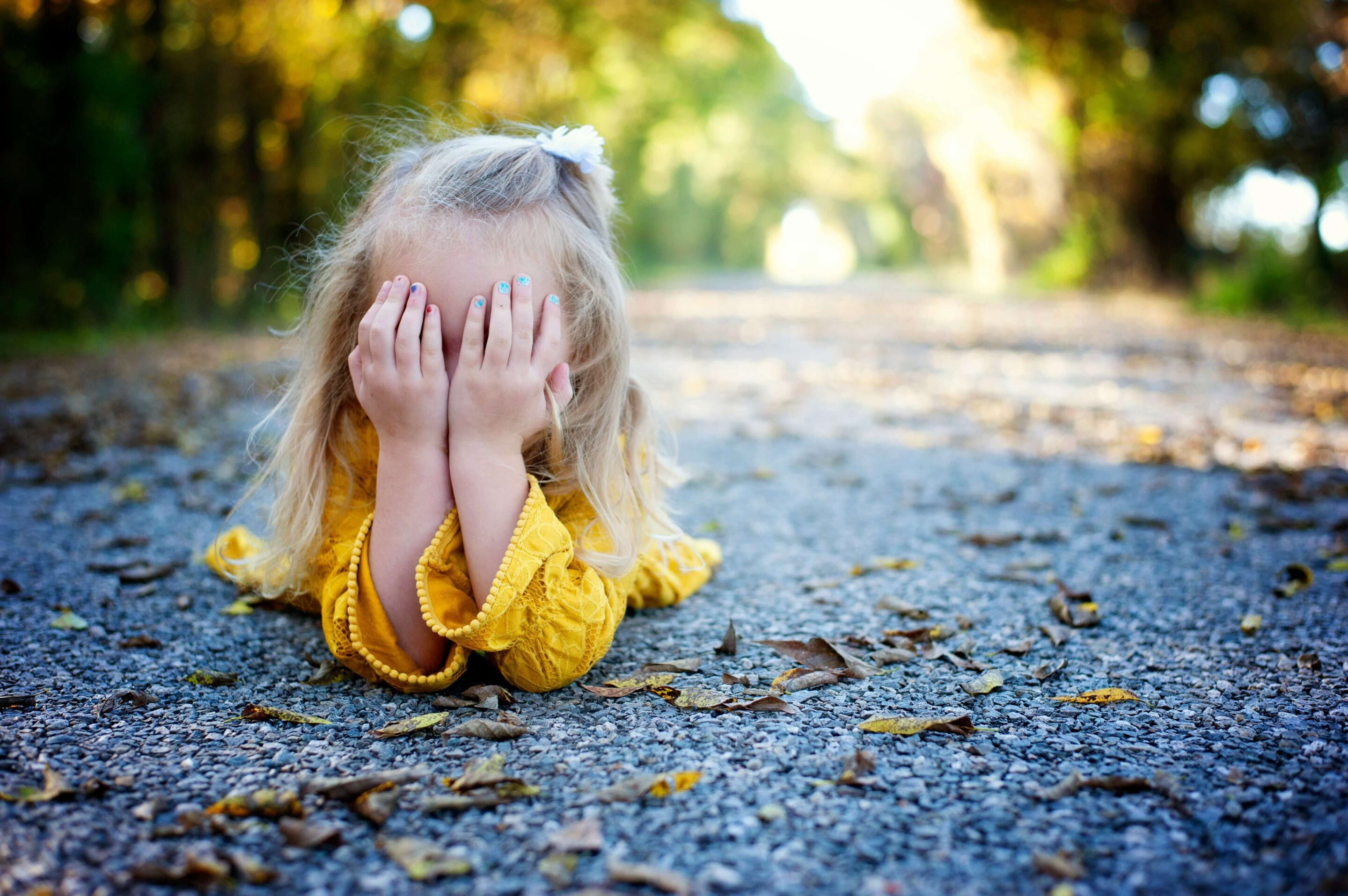 kid covering her face