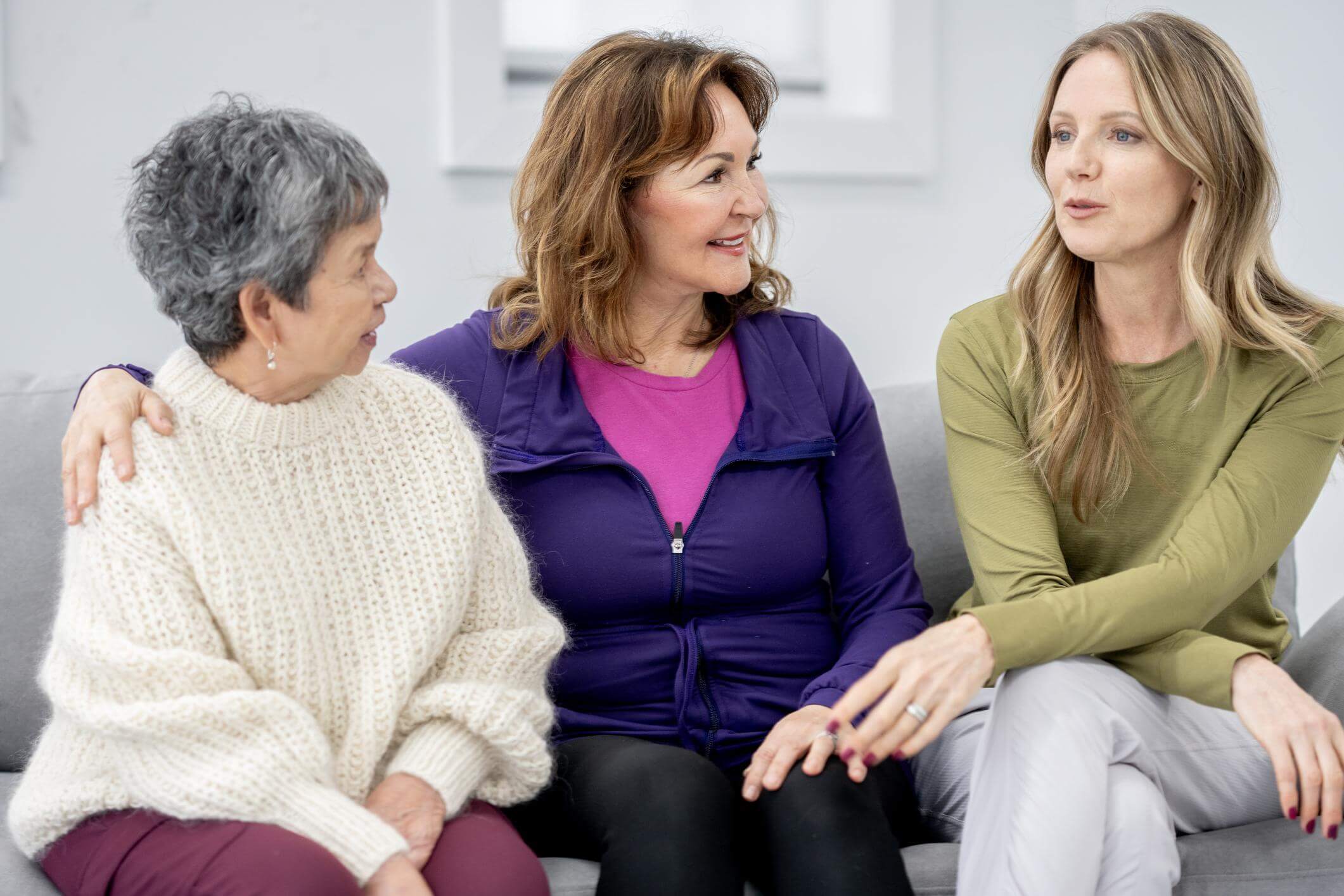 a small group of women of different ages sharing a relaxed, genuine moment